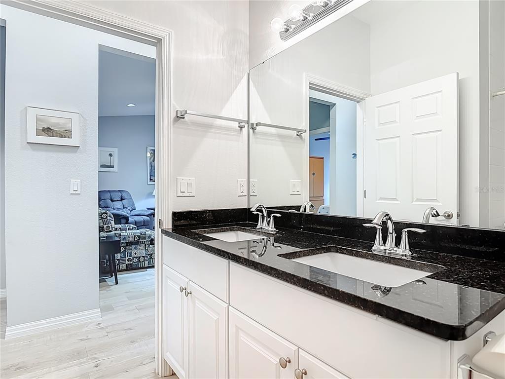 202 Walter Stevens Way DeLand, FL 32724 - Photo 24 of 34 a bathroom with a granite countertop sink and a mirror