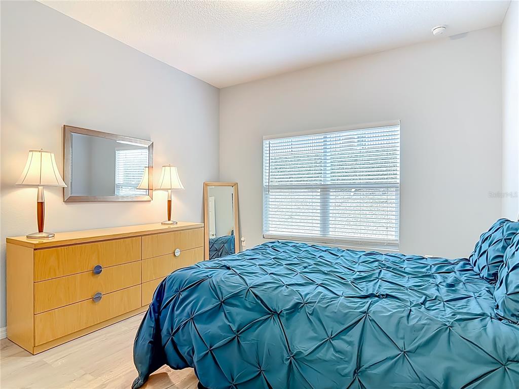 202 Walter Stevens Way DeLand, FL 32724 - Photo 25 of 34 a bedroom with a bed and a dresser