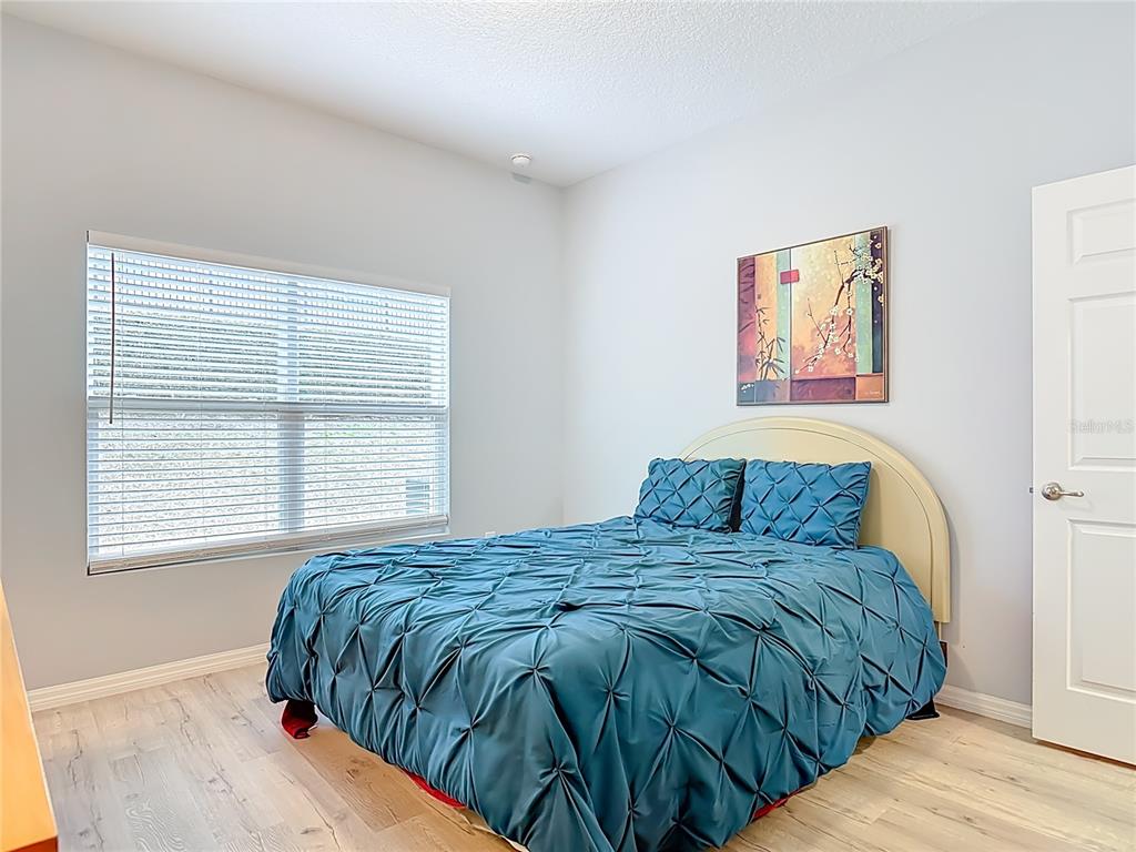 202 Walter Stevens Way DeLand, FL 32724 - Photo 26 of 34 a bedroom with a bed and a window