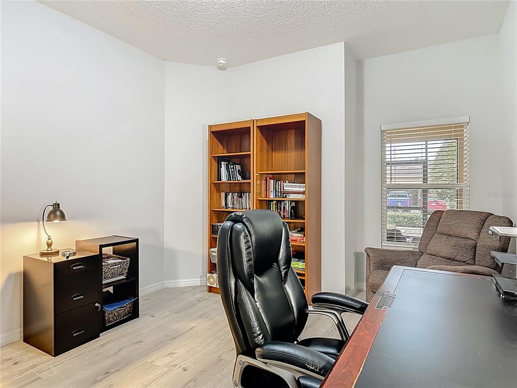 202 Walter Stevens Way DeLand, FL 32724 - Photo 28 of 34 a view of a workspace with furniture and a window