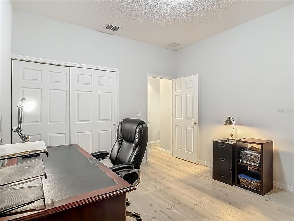 202 Walter Stevens Way DeLand, FL 32724 - Photo 29 of 34 a view of a workspace with furniture and a window
