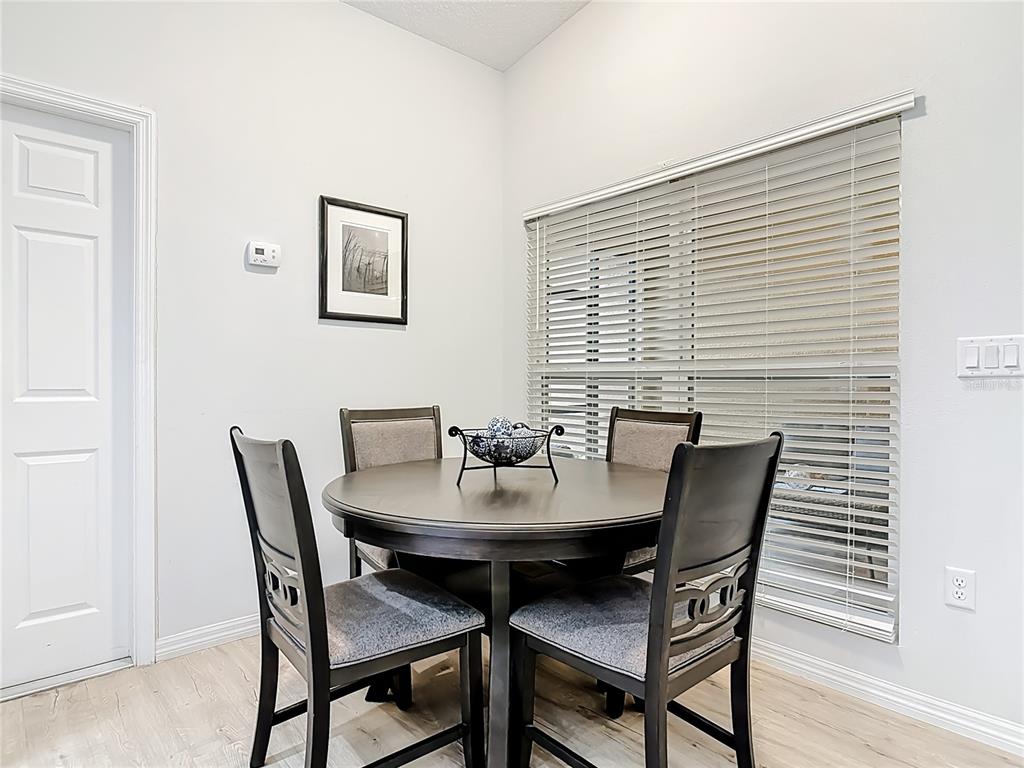 202 Walter Stevens Way DeLand, FL 32724 - Photo 7 of 34 a view of a dining room with tables and chairs