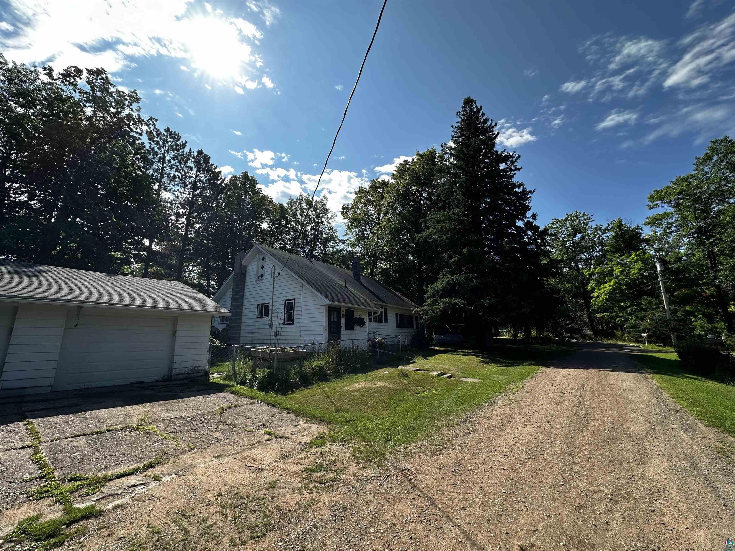 8372 Garden Street Kerrick, MN 55756 - Photo 1 of 24 View of home's exterior with driveway and view of scattered trees