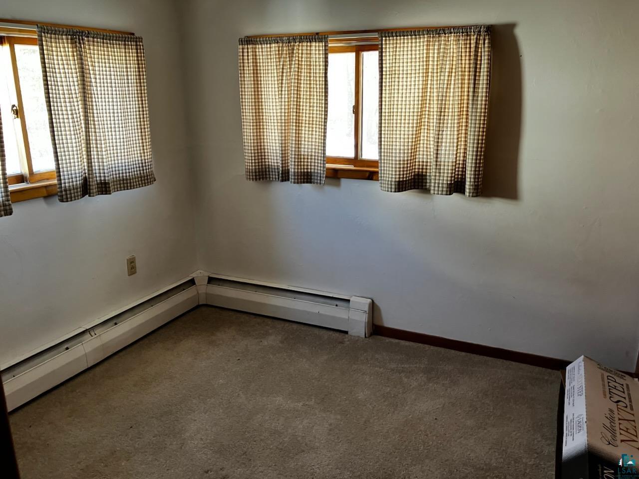 8372 Garden Street Kerrick, MN 55756 - Photo 9 of 24 Unfurnished room featuring baseboards and carpet