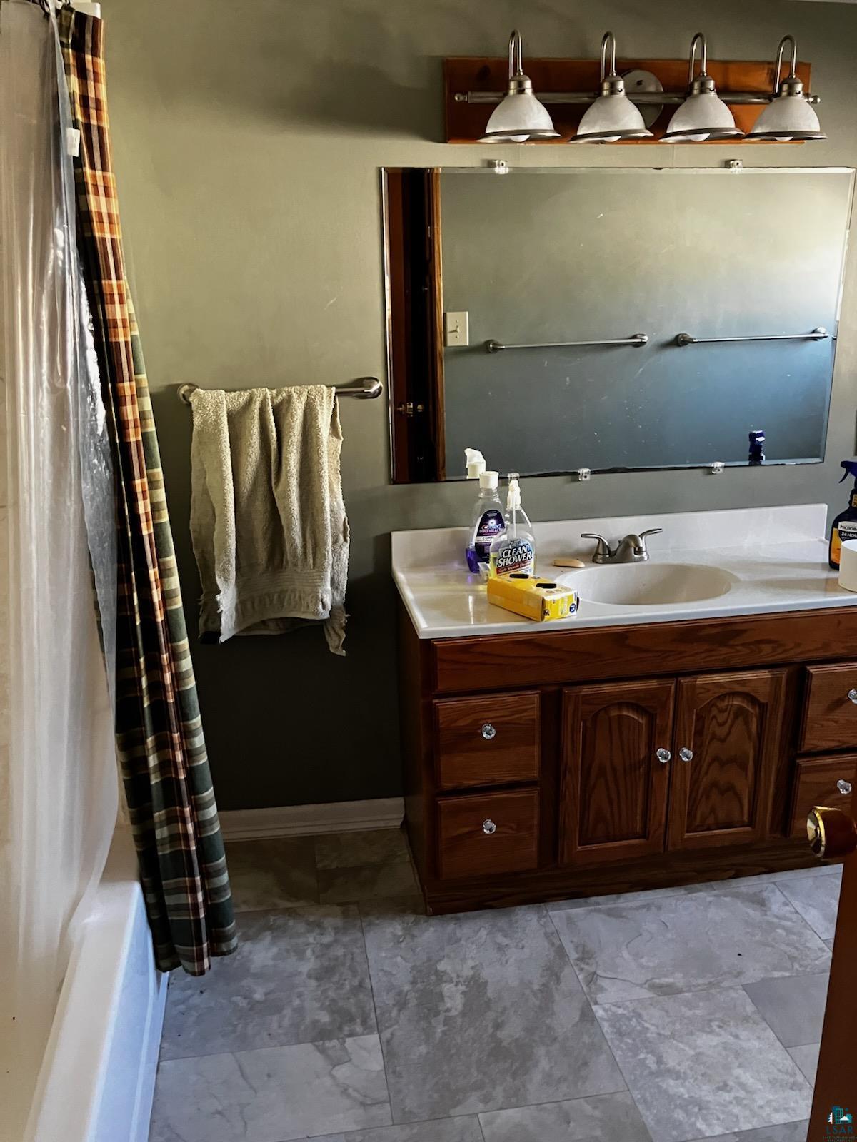 8372 Garden Street Kerrick, MN 55756 - Photo 10 of 24 Full bathroom featuring vanity and baseboards