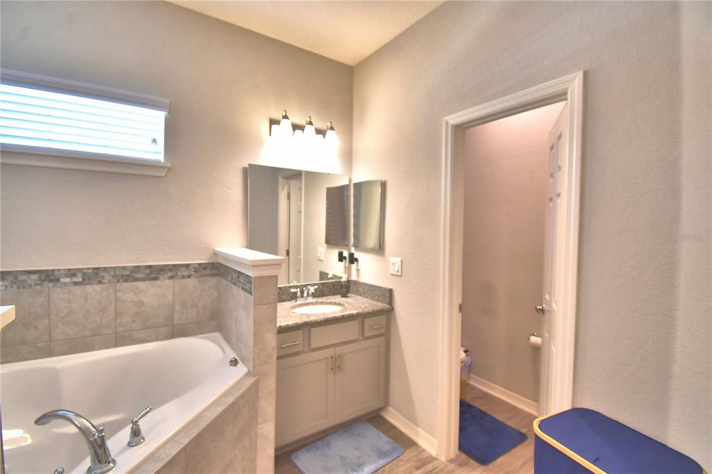 4340 Reding Way Lakeland, FL 33813 - Photo 46 of 63 a bathroom with a tub sink and mirror