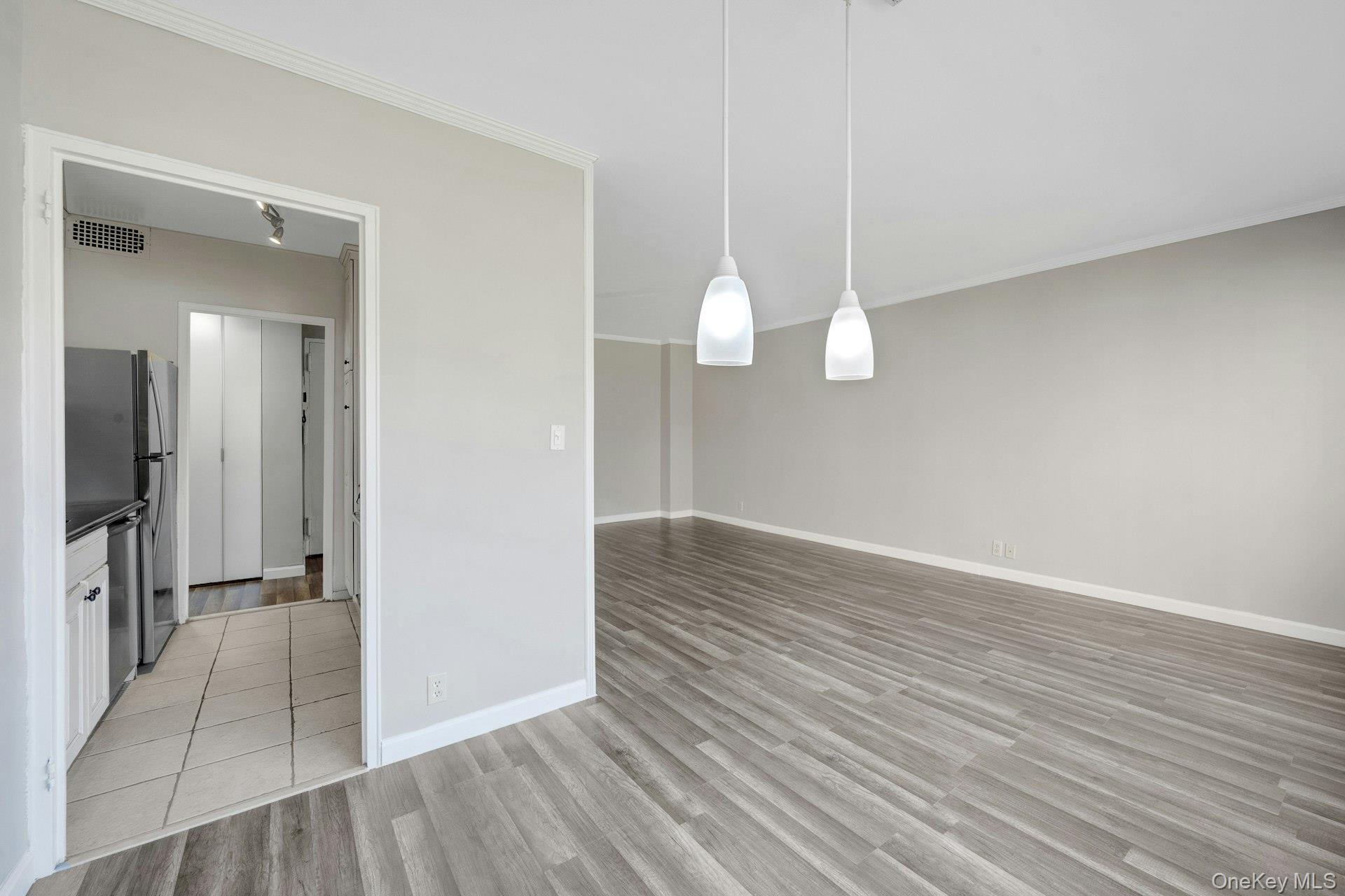 240 Garth Road, Unit 2G2 Scarsdale, NY 10583 - Photo 10 of 25 View of dining area, living room, and kitchen
