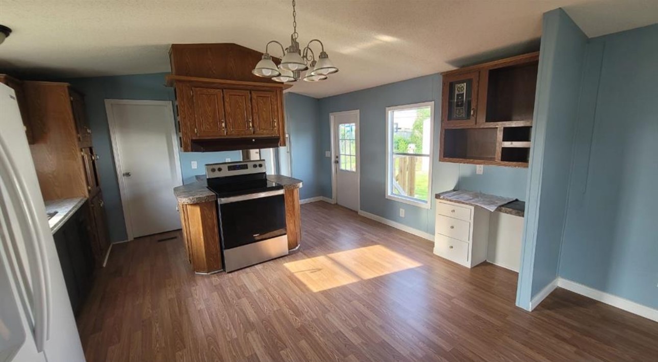1403 Old Greens Road Houston, TX 77032 - Photo 11 of 19 a kitchen with stainless steel appliances wooden floor and a refrigerator