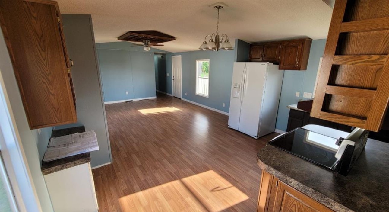 1403 Old Greens Road Houston, TX 77032 - Photo 16 of 19 a kitchen with wooden floor and electronic appliances