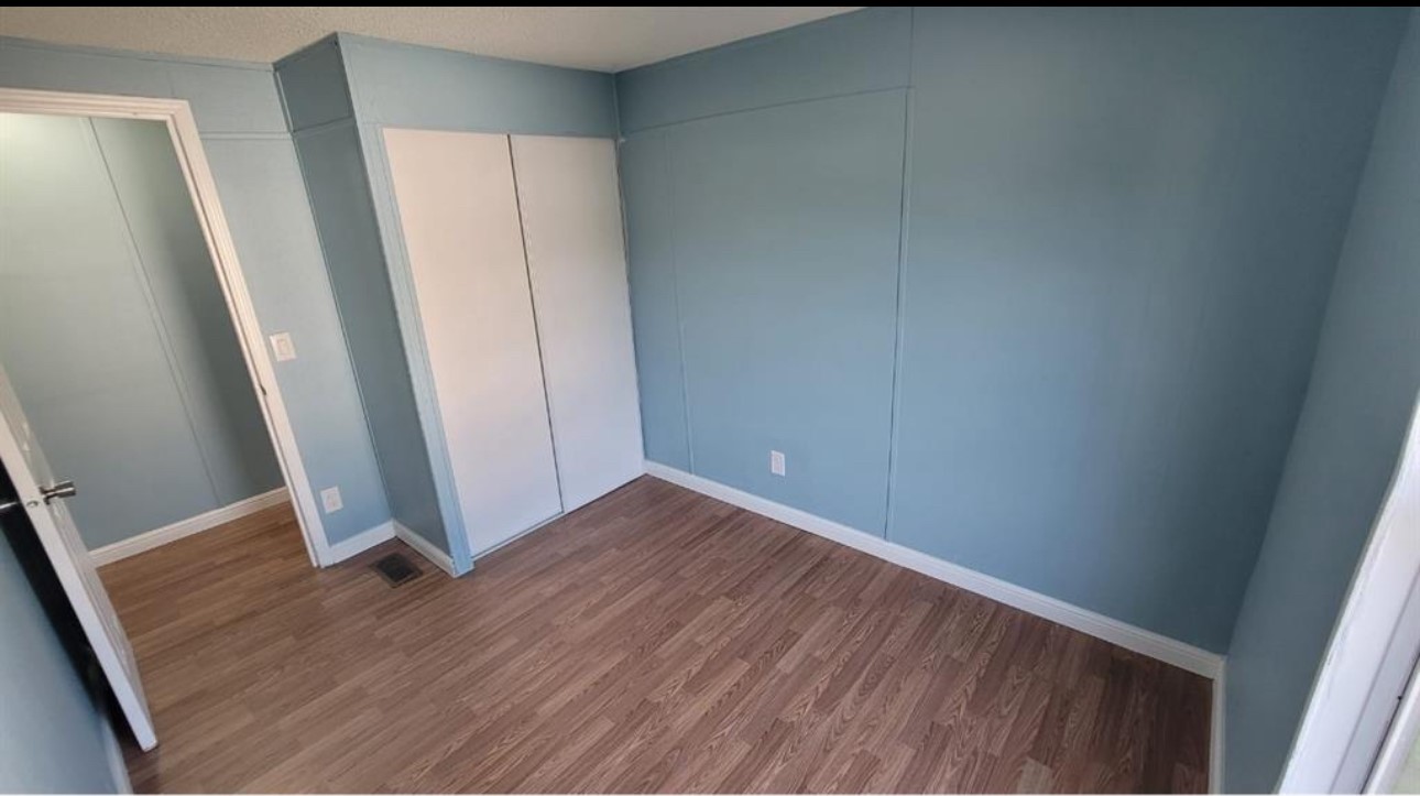 1403 Old Greens Road Houston, TX 77032 - Photo 7 of 19 an empty room with wooden floor