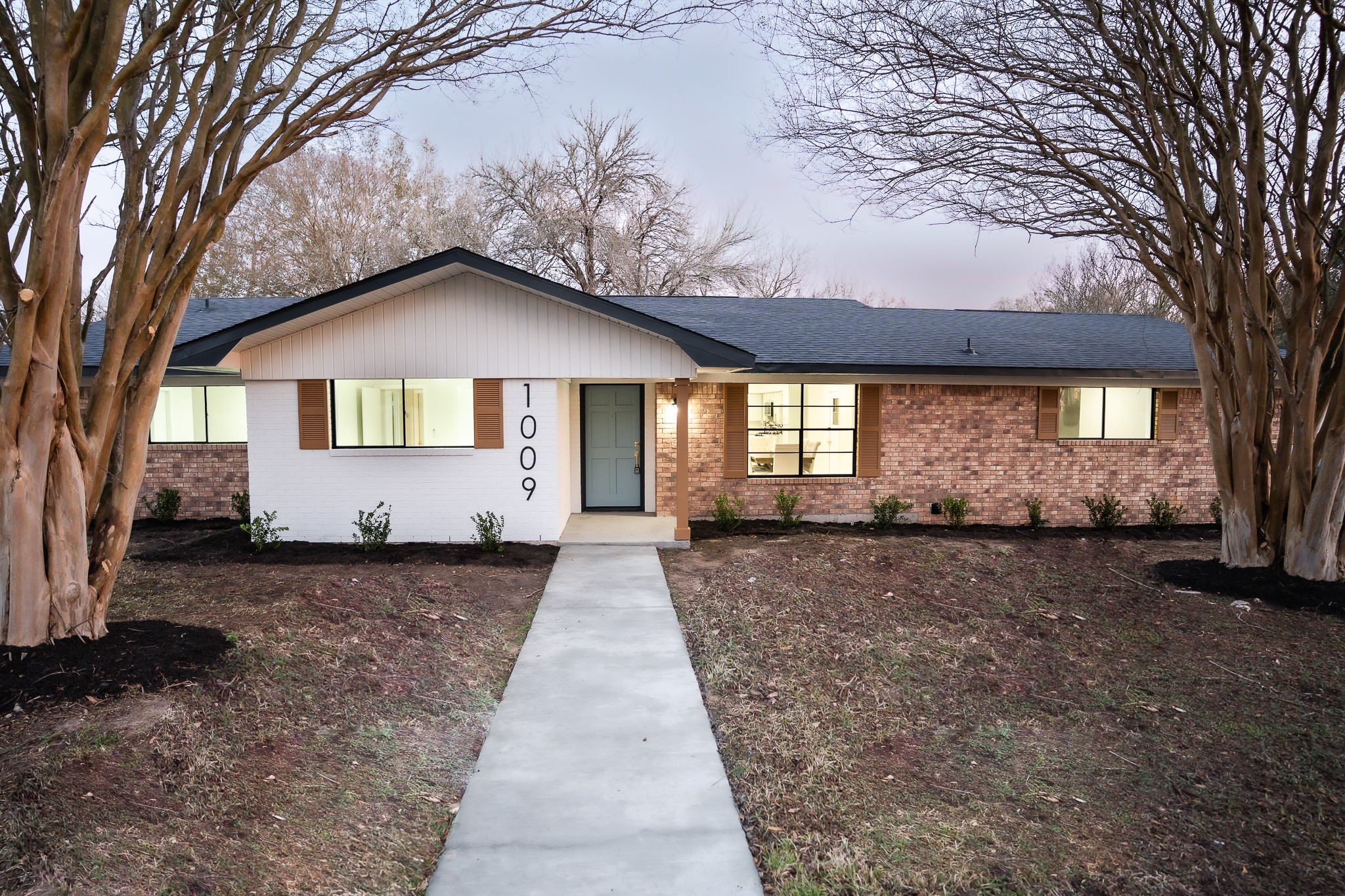 a front view of a house with a yard