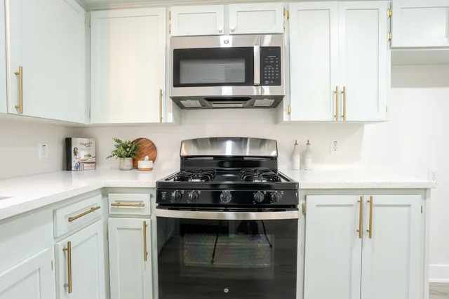 a kitchen with stainless steel appliances a stove a microwave and cabinets