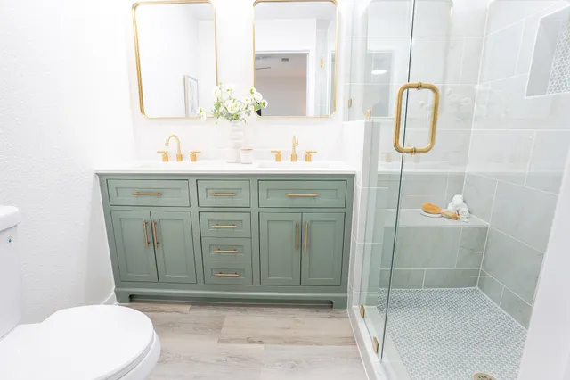 a bathroom with a sink a toilet and mirror