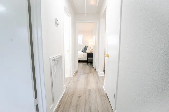 a view of a bedroom with wooden floor