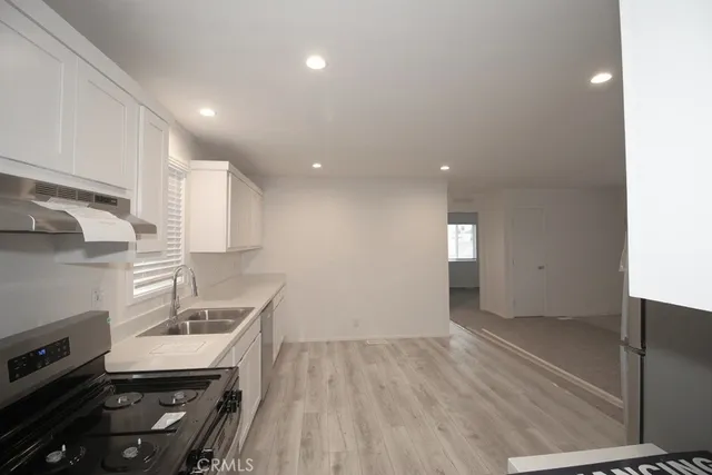 a kitchen with granite countertop a stove and a sink