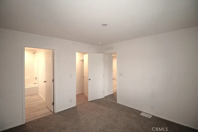 an empty room with closet area