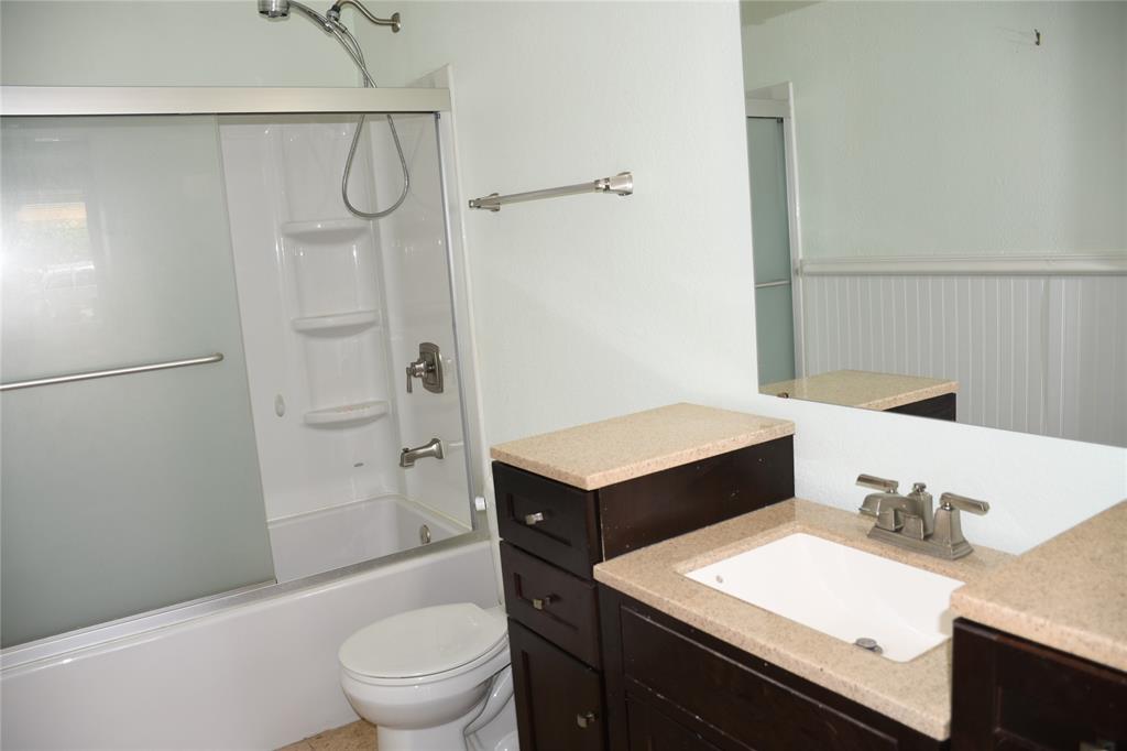 6241 Peach Tree Drive Midlothian, TX 76065 - Photo 10 of 19 Bathroom featuring a dark wood-finish vanity with an integrated sink, a light-toned countertop, and a large wall-mounted mirror
