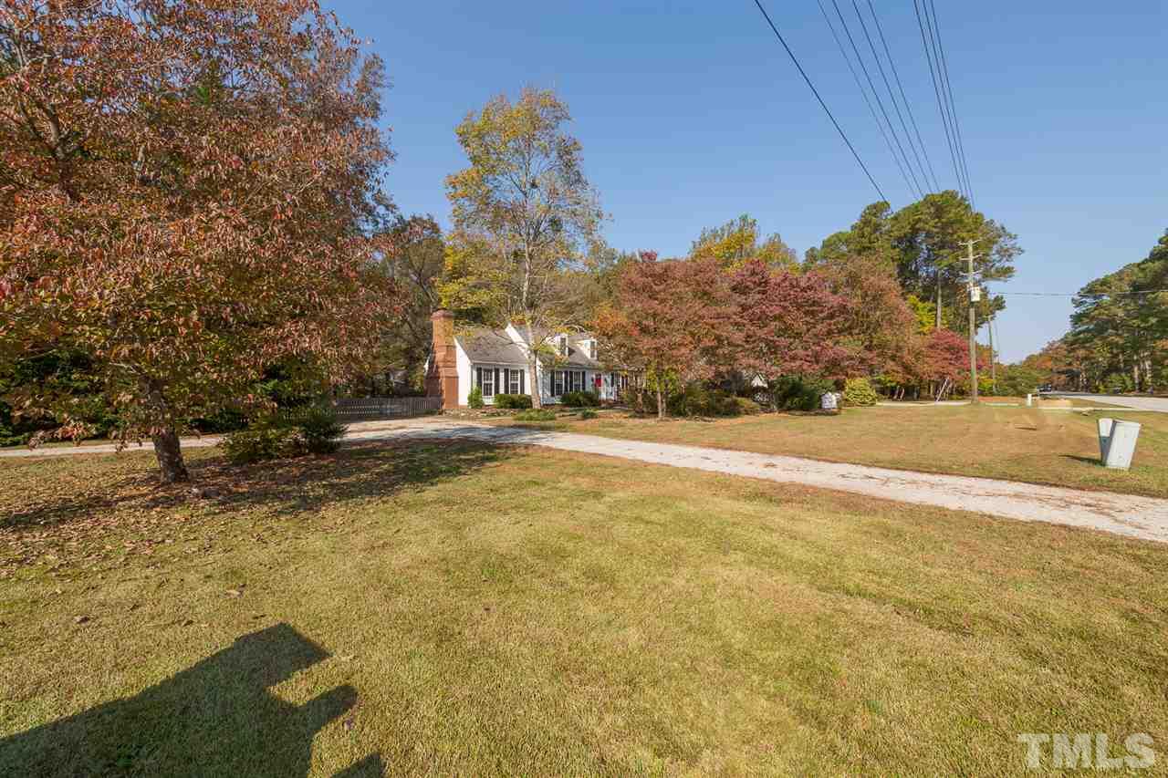 8236 Bells Lake Road Apex, NC 27539 - Photo 18 of 25 Your green front yard features hardwood trees, beautiful landscaping, and offers driveway access from both streets.