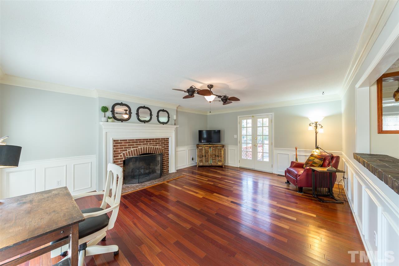 8236 Bells Lake Road Apex, NC 27539 - Photo 4 of 25 Enjoy gathering around the brick fireplace in the crisp fall evenings. Your large living room also features gleaming hardwood floors.