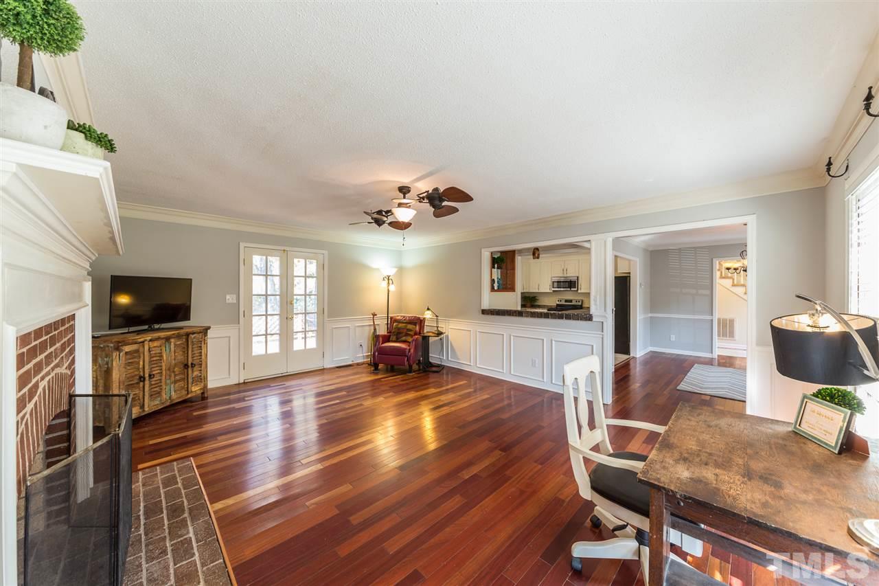 8236 Bells Lake Road Apex, NC 27539 - Photo 5 of 25 Don't you love the moldings and wainscoting around the living room. Flooded with natural light and with easy access to the kitchen and dining room, this space is ideal for entertaining.