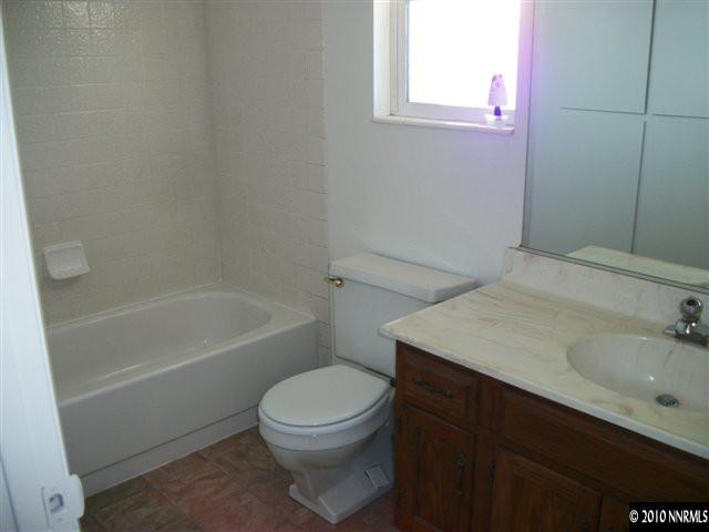 1702 Del Rosa Way Sparks, NV 89434 - Photo 8 of 11 a bathroom with a sink a toilet and shower
