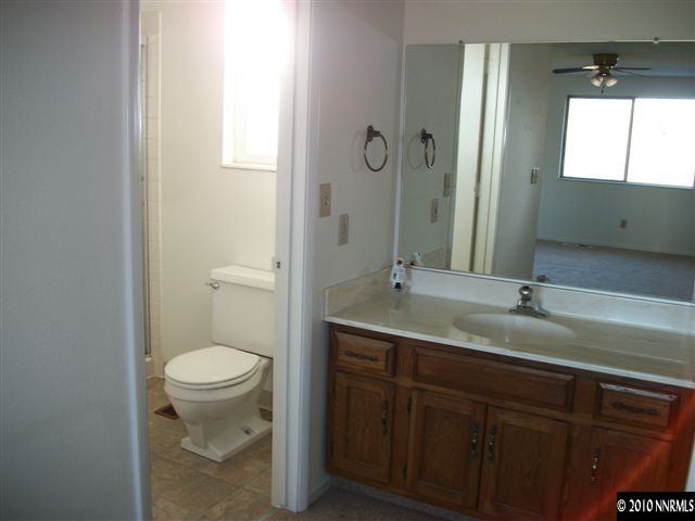 1702 Del Rosa Way Sparks, NV 89434 - Photo 10 of 11 a bathroom with a granite countertop sink toilet and mirror
