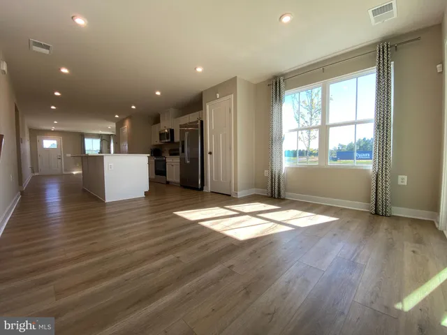 a view of an empty room and wooden floor