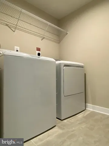 a spacious bathroom with a double vanity sink a toilet and a mirror