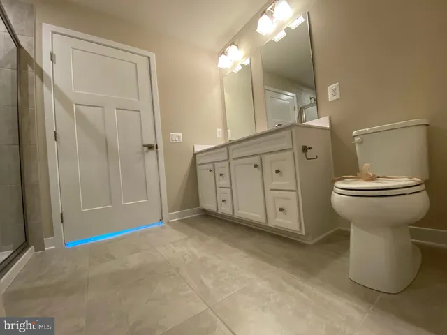 a view of a big room with wooden floor and windows