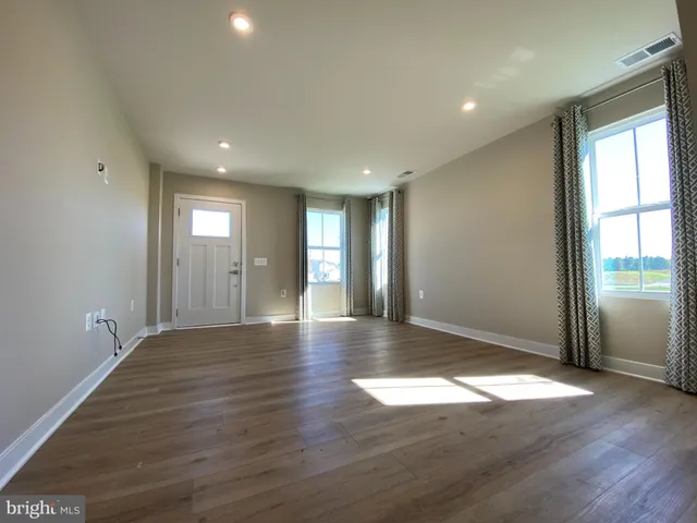 a large kitchen with stainless steel appliances granite countertop a large counter top and a stove top oven