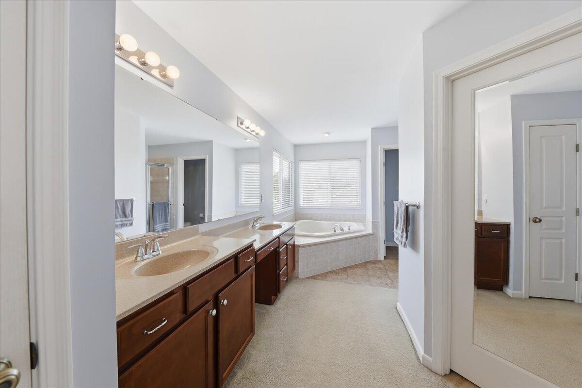 796 Rudolph Way Erlanger, KY 41018 - Photo 32 of 49 796 Rudolph Way, Erlanger KY 41018-Dual vanity with integrated sinks, expansive wall-mounted mirror, built-in soaking tub, and tile flooring