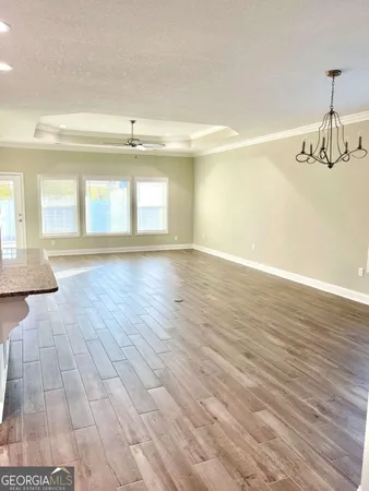 a kitchen with granite countertop a refrigerator and a sink