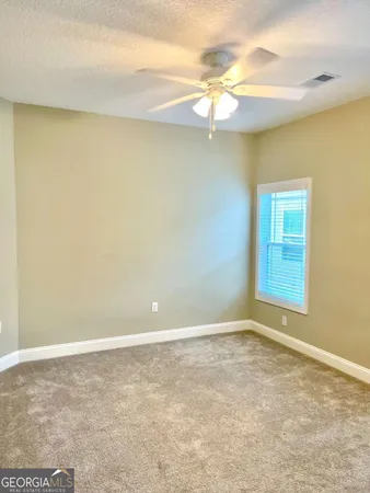 an empty room with a empty space and windows