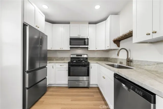 a kitchen with a refrigerator stove and sink