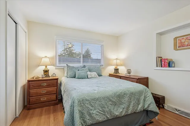a bedroom with a bed and wooden floor