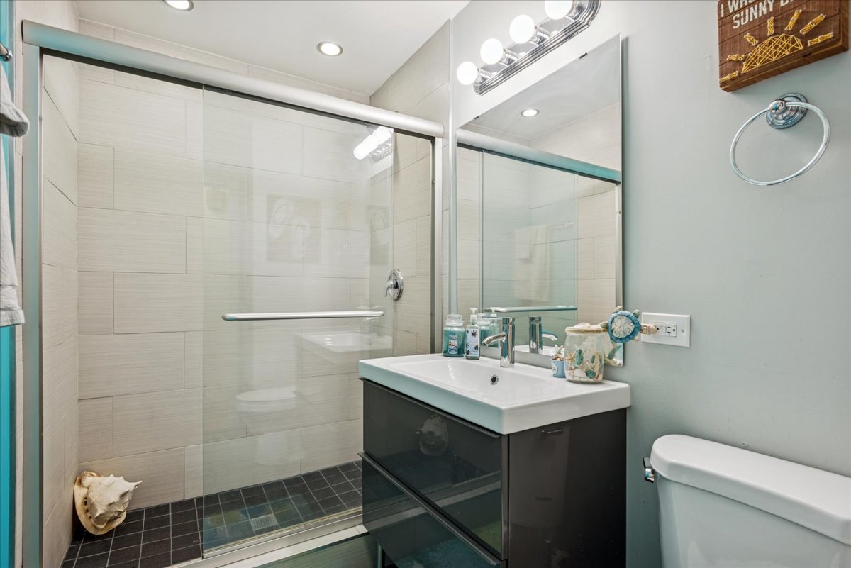 512 Busse Road Mount Prospect, IL 60056 - Photo 14 of 24 a bathroom with a sink mirror and toilet