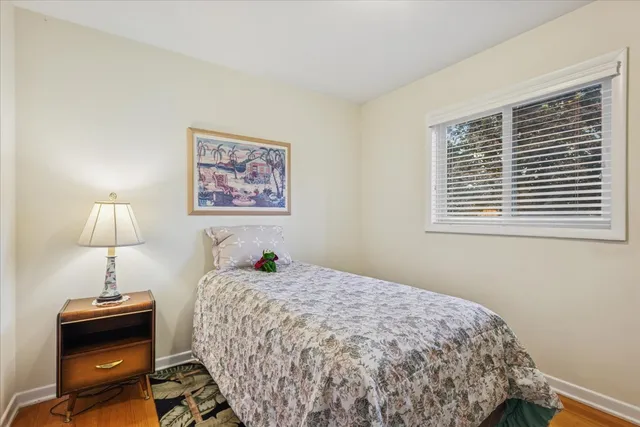a bedroom with a bed and a lamp on table