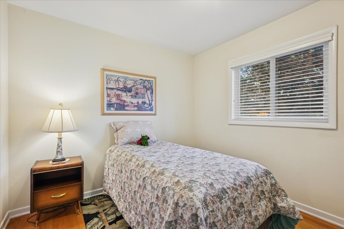 512 Busse Road Mount Prospect, IL 60056 - Photo 15 of 24 a bedroom with a bed and a lamp on table
