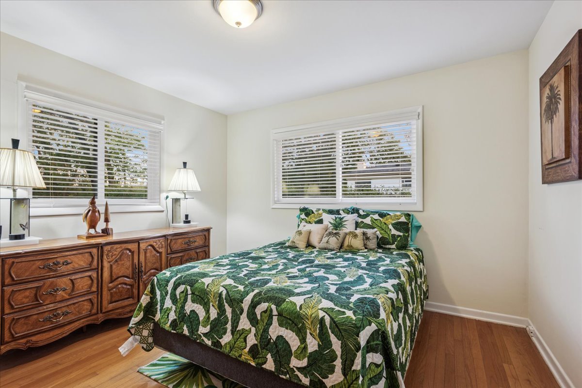 512 Busse Road Mount Prospect, IL 60056 - Photo 16 of 24 a bed sitting in a bedroom next to a window