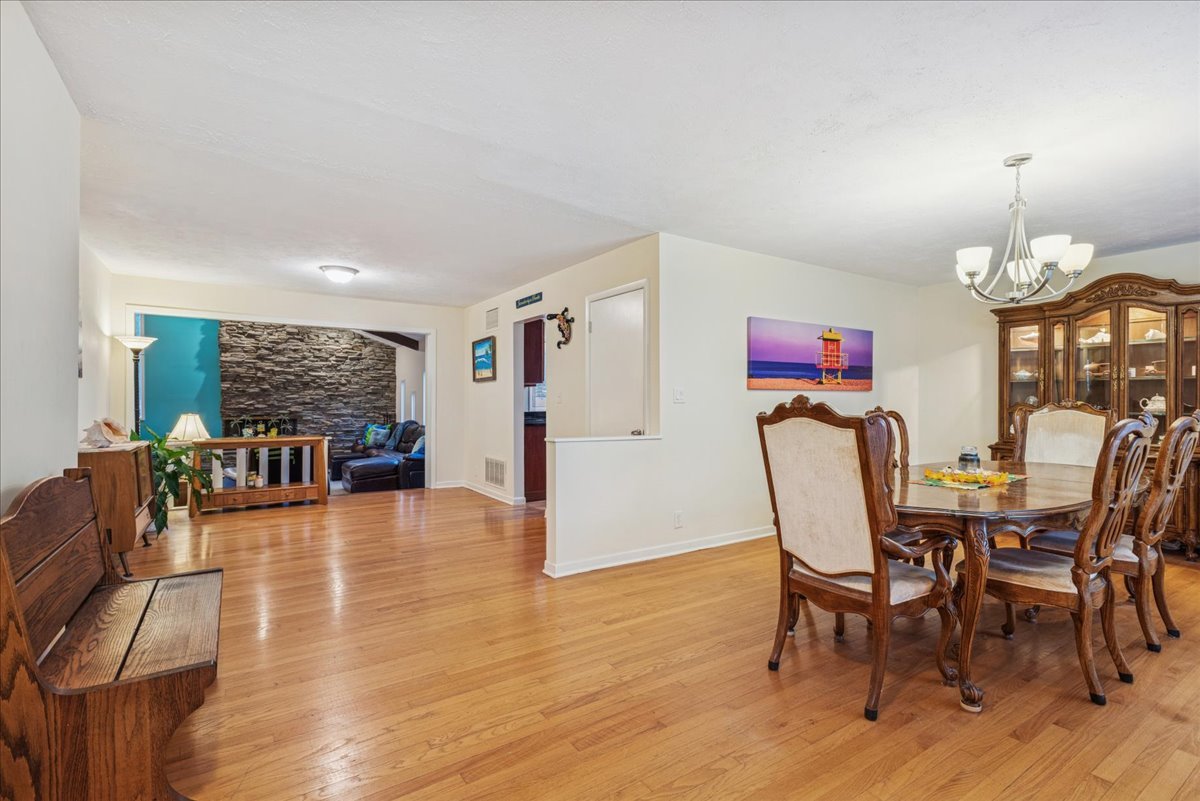 512 Busse Road Mount Prospect, IL 60056 - Photo 3 of 24 a view of a dining room with furniture and wooden floor