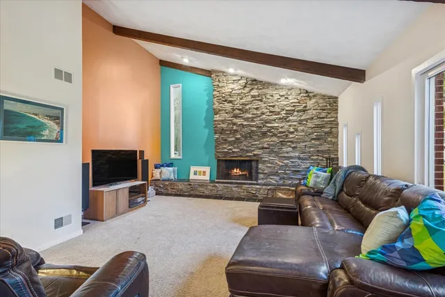 a living room with furniture flat screen tv and a fireplace