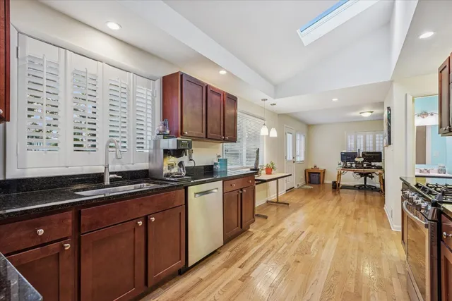 a kitchen with lots of counter top space and wooden floor