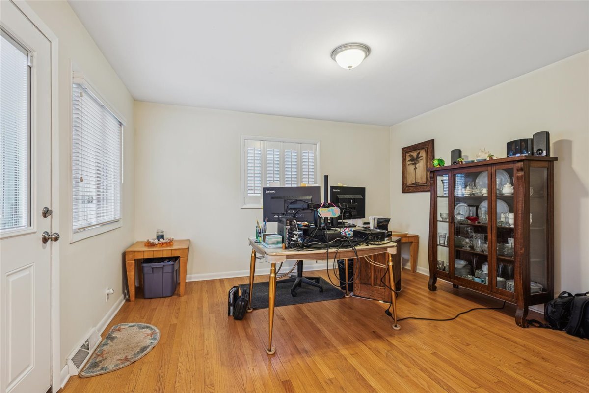 512 Busse Road Mount Prospect, IL 60056 - Photo 10 of 24 a work room with furniture and wooden floor