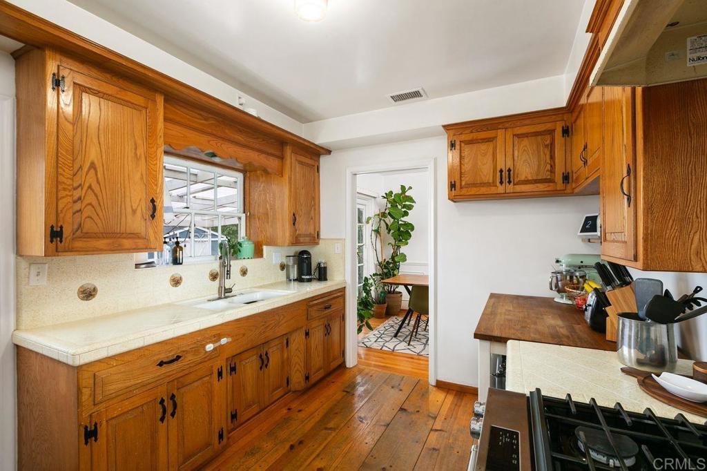 4321 Gordon Way La Mesa, CA 91942 - Photo 11 of 27 a large white kitchen with a window
