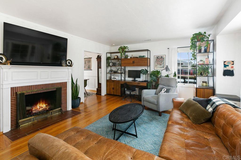 4321 Gordon Way La Mesa, CA 91942 - Photo 5 of 27 a living room with furniture a flat screen tv and a fireplace
