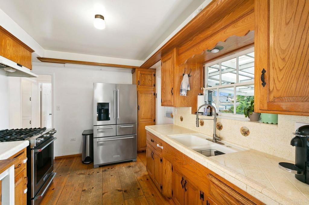 4321 Gordon Way La Mesa, CA 91942 - Photo 10 of 27 a kitchen with stainless steel appliances a sink and a large window