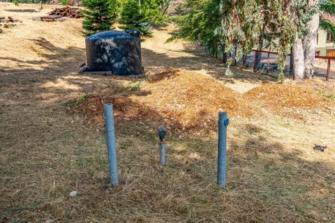 a view of a yard with wooden fence