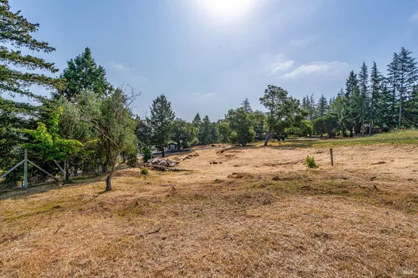 a view of a dirt road with a building in the background