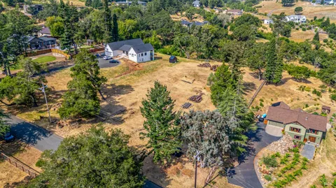 an aerial view of a house with a yard and swimming pool