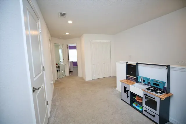 a bedroom with a bed dresser and a window